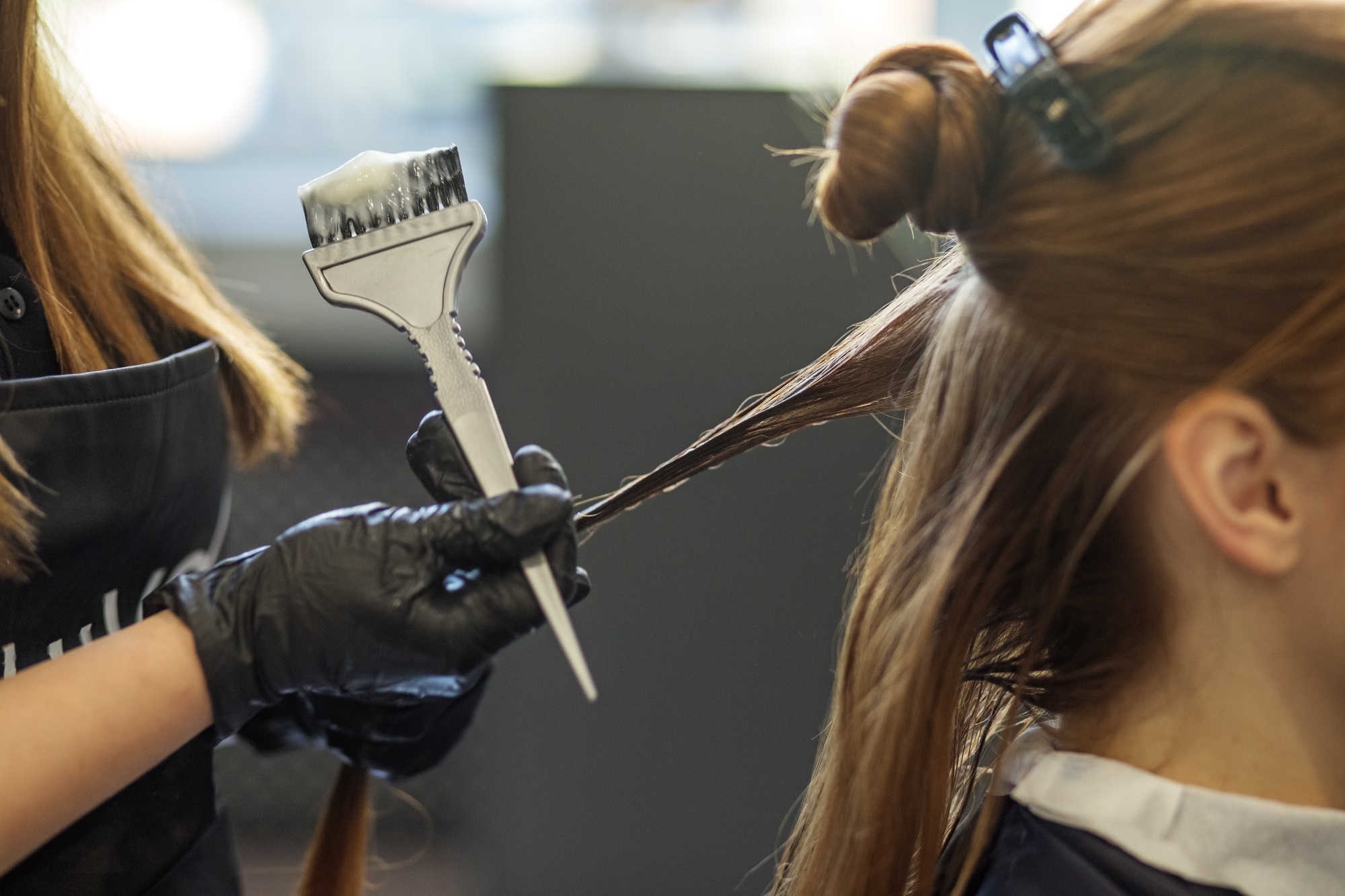 Procoiffure -Procoiffure hairdresser applies color to long hair image change concept hair care small business